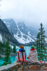 Enchanting Winter Wonderland: Moraine Lake's Snowy Serenity Amidst the Clouds