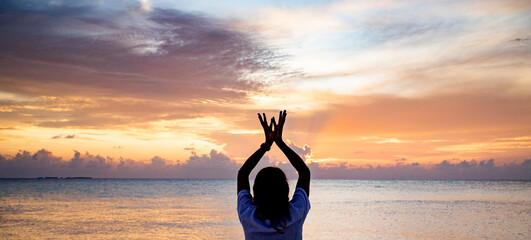 hand in lotus mudra at sunset