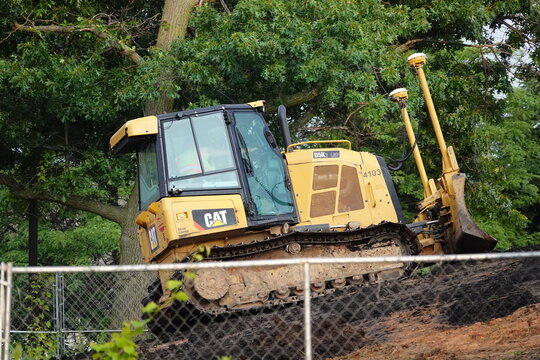 Caterpillar D9 bulldozer moving dirt material around to flatten the land to construct the foundation of the expansion of highway 23.