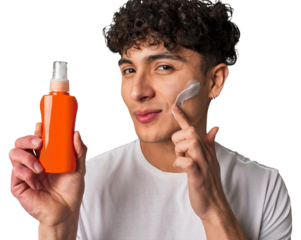 A young man protects his skin from harmful UV rays, applying non-greasy, broad-spectrum sunscreen for a healthy and youthful look.