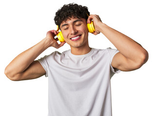 A young man enjoys his favorite tunes in high-quality sound, using wireless headphones for a...