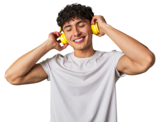 A young man enjoys his favorite tunes in high-quality sound, using wireless headphones for a relaxing and entertaining audio experience.