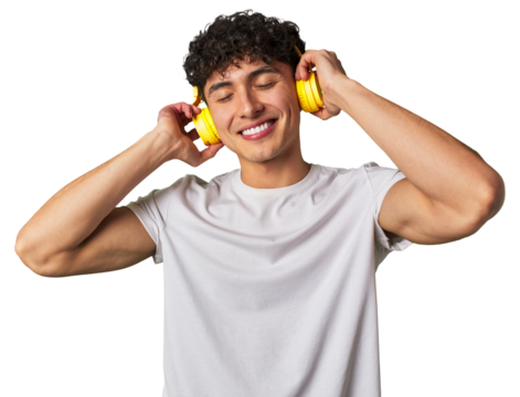 A young man enjoys his favorite tunes in high-quality sound, using wireless headphones for a relaxing and entertaining audio experience.