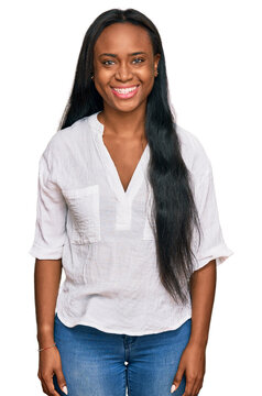 Young black woman wearing casual clothes with a happy and cool smile on face. lucky person.