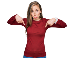 Young blonde woman wearing casual clothes pointing down looking sad and upset, indicating direction with fingers, unhappy and depressed.