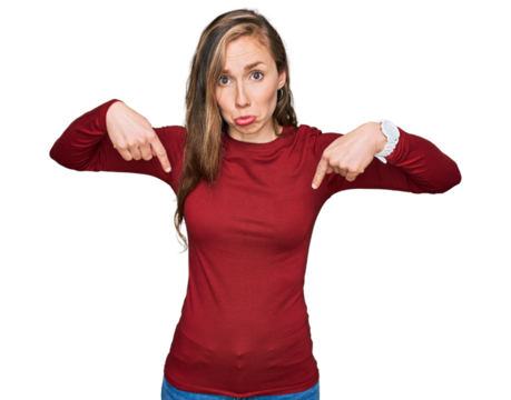 Young blonde woman wearing casual clothes pointing down looking sad and upset, indicating direction with fingers, unhappy and depressed.