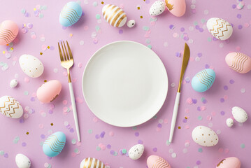 Easter concept. Top view photo of plate cutlery fork knife colorful easter eggs and confetti on...