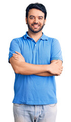 Fototapeta premium Young hispanic man wearing casual clothes happy face smiling with crossed arms looking at the camera. positive person.