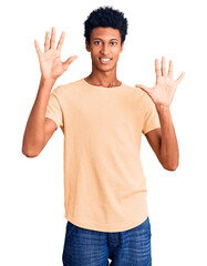 Young african american man wearing casual clothes showing and pointing up with fingers number ten while smiling confident and happy.