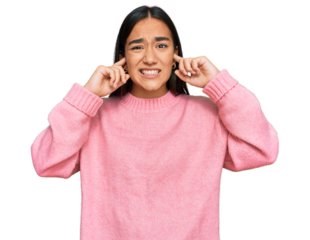 Young asian woman wearing casual winter sweater covering ears with fingers with annoyed expression for the noise of loud music. deaf concept.