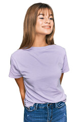 Obraz premium Teenager caucasian girl wearing casual clothes looking away to side with smile on face, natural expression. laughing confident.