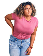 Young african american plus size woman wearing casual clothes suffering of backache, touching back with hand, muscular pain