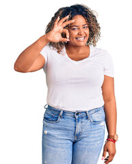 Young african american plus size woman wearing casual clothes smiling positive doing ok sign with hand and fingers. successful expression.