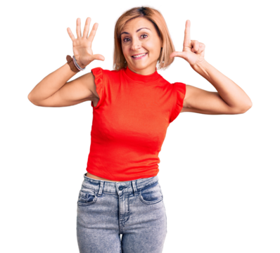 Young blonde woman wearing casual clothes showing and pointing up with fingers number seven while smiling confident and happy.