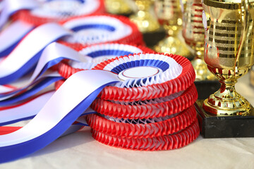 Pile of horse sport trophies rosettes at equestrian event