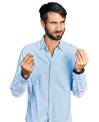 Hispanic man with blue eyes wearing business shirt doing money gesture with hands, asking for salary payment, millionaire business