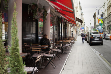 Street cafe with wooden terrace furniture. tables and chairs at restaurant