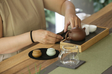 Chinese Tea Ceremony experience. Exquisite hot tea at traditional Chinese Tea Ceremony. Group of women participating in a traditional tea ceremony class, serie of photos.