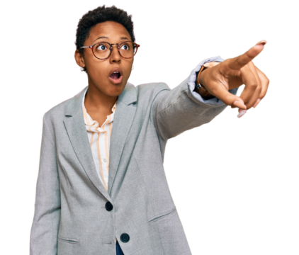 Young african american woman wearing business clothes pointing with finger surprised ahead, open mouth amazed expression, something on the front