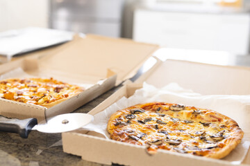 Close up of countertop in kitchen with pizza in boxes