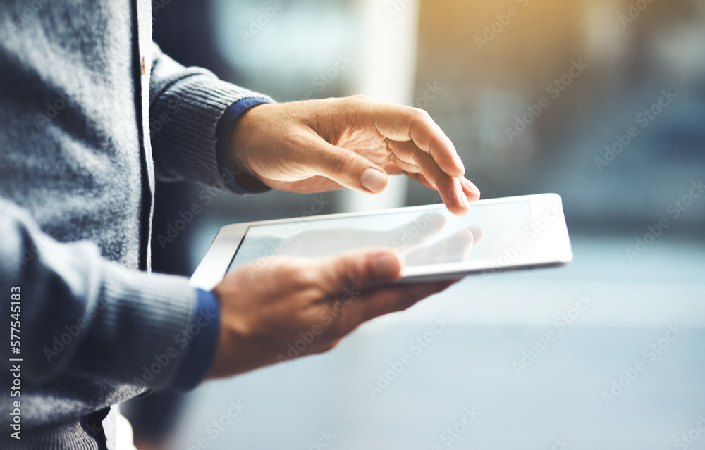 Poster its the handiest device you could use. closeup shot of an unrecognisable businessman using a digital
