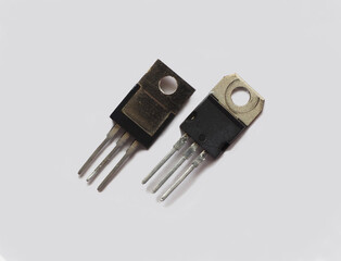 Plastic sheathed transistors isolated on grey background.     