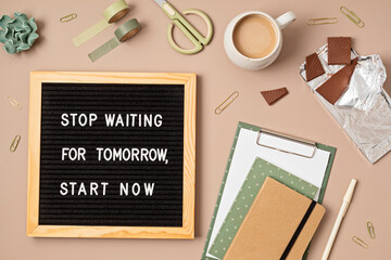 Flatlay of letter board with motivational quote Stop waiting for tomorrow, start now. Office supplies made of recycled materials on beige background