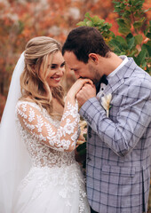 Wedding kiss. Groom kisses bride's hand. Weddng love. Boho style