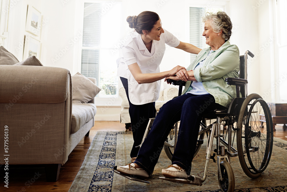 Wall mural The best care you could hope for. Shot of a smiling caregiver helping a senior woman in a wheelchair at home.