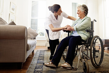The best care you could hope for. Shot of a smiling caregiver helping a senior woman in a wheelchair at home. - obrazy, fototapety, plakaty