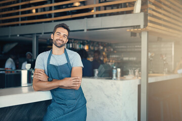 How can I make your coffee dreams come true. Portrait of a young man working in a cafe.