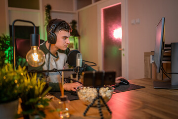 oung man male gamer playing computer game streaming video winning