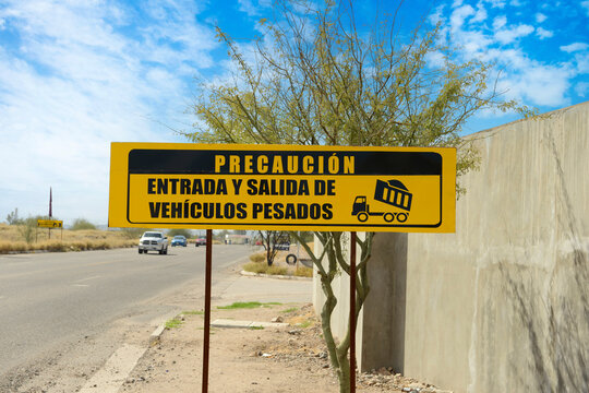 Caution entry and exit of heavy vehicles sign in Spanish, seen in Mexico