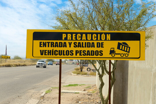 Caution entry and exit of heavy vehicles sign in Spanish, seen in Mexico