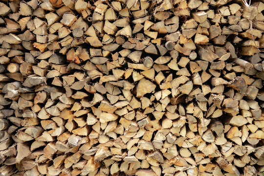 textured firewood background of chopped wood for kindling and heating the house