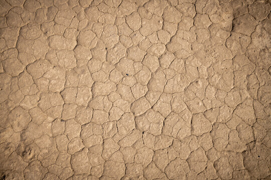 Dry desert ground cracked from the scorching sun.