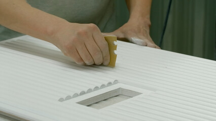 Close-up of carpenter polishing product. Creative. Man polishes lines on wooden board with hands....