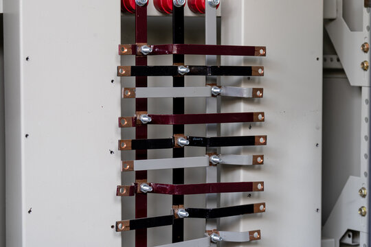 Assemble and install the busbar panel in the electrical system cabinet.
