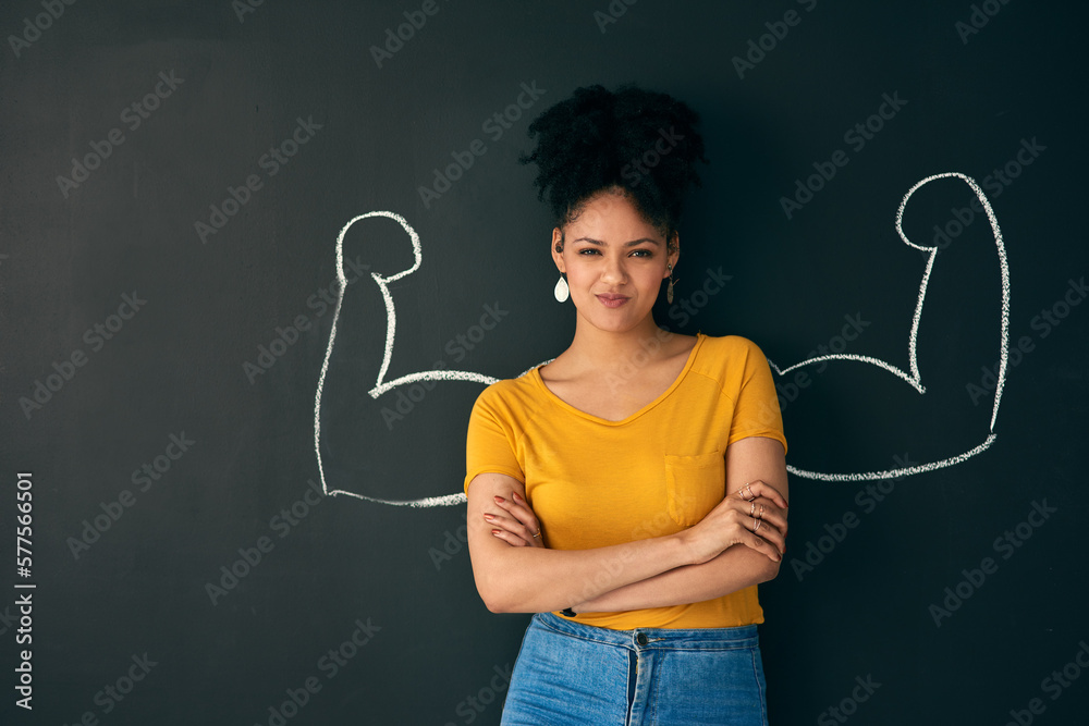 Canvas Prints I am a strong woman. Shot of a woman posing with a chalk illustration of flexing muscles against a dark background.