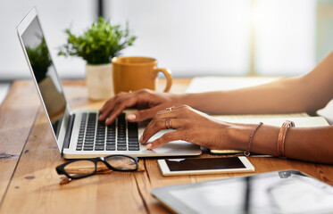 Shes a fast typer. Shot of an unrecognizable woman working from home.