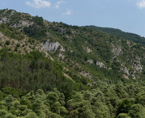 Rhodopes, are a mountain range in Southeastern Europe. Bulgaria. Panorama. The forest area covers the mountains.