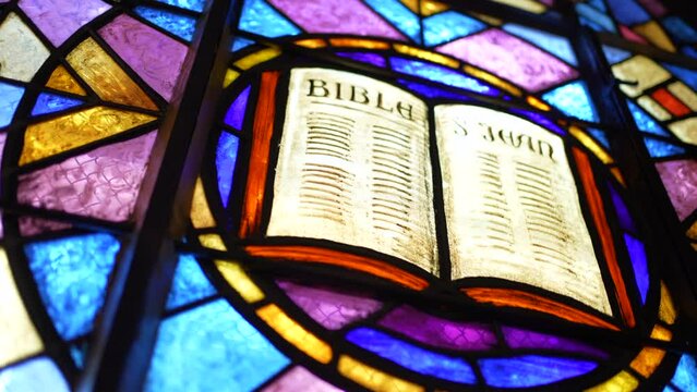Stained Catholic Church glass with image of the Bible Scripture inside Religious place