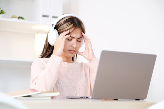 Young asian woman stress while working with laptop computer at home office