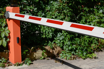 Closed boom barrier outdoors on sunny day, closeup