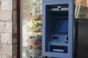 Automated teller machine outdoors on sunny day. Space for text