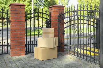 Fototapeta na wymiar Stack of parcels delivered near front gates