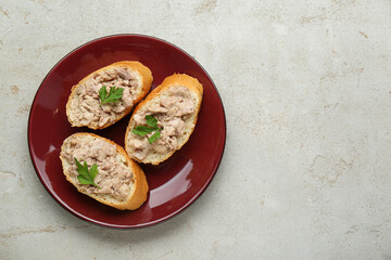 Tasty sandwiches with cod liver on light grey table, top view. Space for text