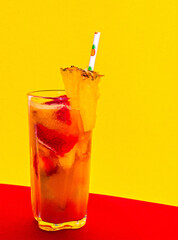 Strawberry, pineapple, mango and fruit punch cocktail with pineapple garnish