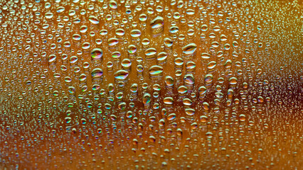 Water drops. Abstract gradient background. Colored drop texture. Rainbow gradient. Heavily textured image. Small depth of field. Selective focus