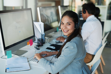 Fototapeta na wymiar Her clients appreciate her friendly demeanor. Portrait of a happy and confident young woman working in a call center.